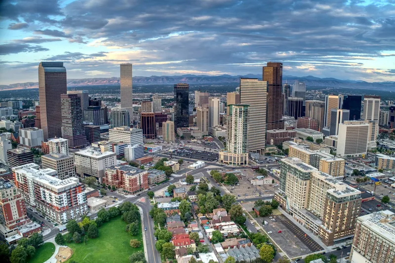 Aerial view of downtown Denver with the Front Range rising on the western horizon