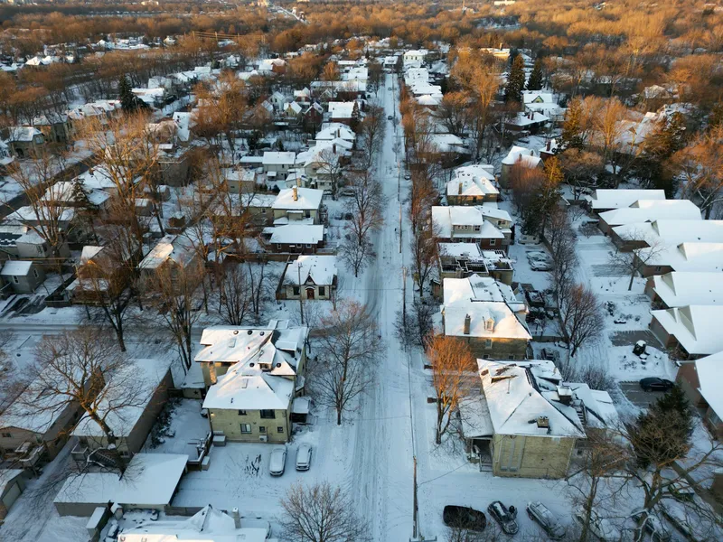 Snow lying across a quiet Frederick street on a gray Carbon Valley morning